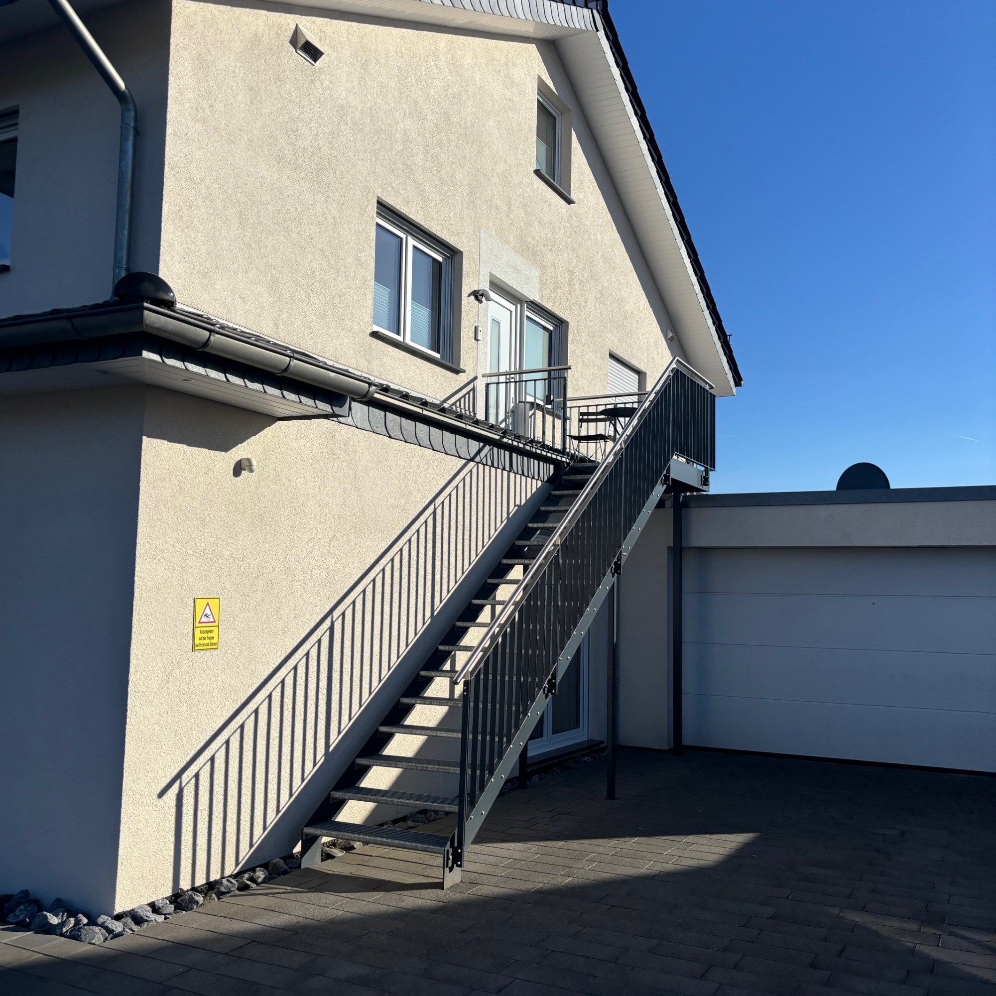 Außenansicht des Hauses mit Fenster und Treppe zum Apartment im Obergeschoss