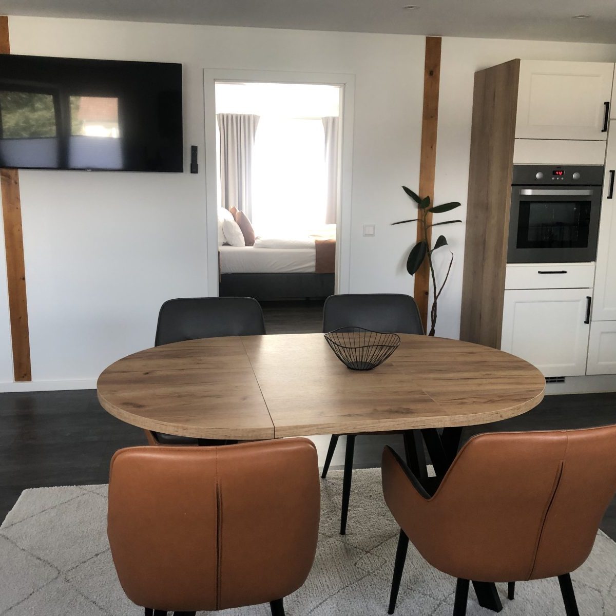 Großer Esstisch mit integrierter Fernsehmöglichkeit – ideal für gemeinsames Essen und Entertainment im Apartment Augustdorf